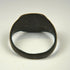 Ancient bronze jewelry from the Roman Empire with decorated flat bezel and centuries-old surface wear