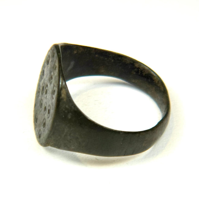 Ancient Roman finger ring featuring simple geometric bezel decoration and intact rounded band