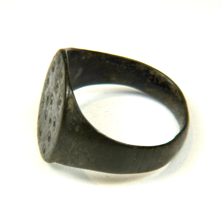 Ancient Roman finger ring featuring simple geometric bezel decoration and intact rounded band