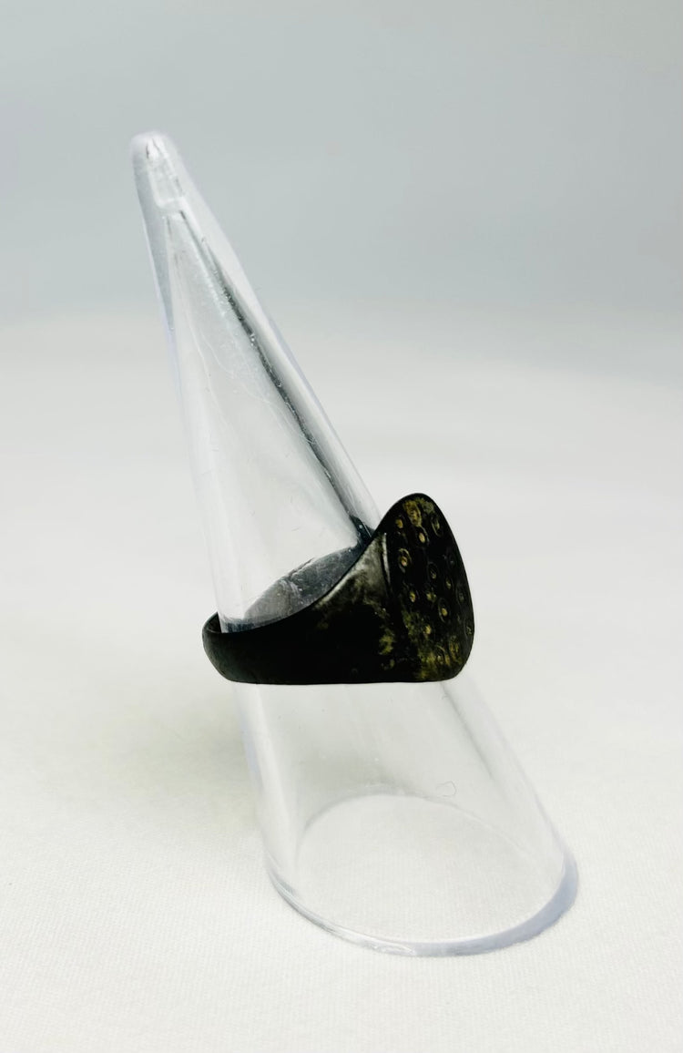 Macro image of an ancient Roman bronze ring emphasizing craftsmanship and age patina