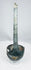 Side view of ancient bronze ladle showing long slightly curved handle
