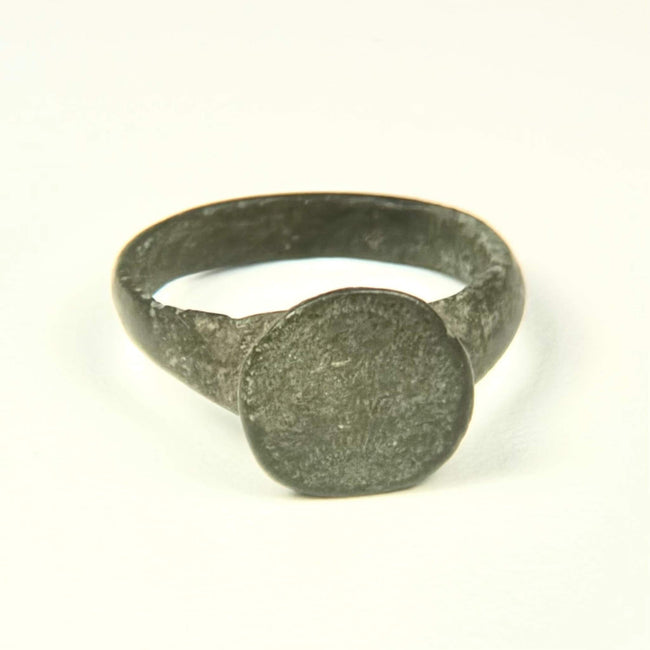Roman to Early Byzantine bronze ring, US size 8, with broad circular bezel and intact tapered hoop, circa 1st–8th century CE