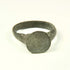 Roman to Early Byzantine bronze ring, US size 8, with broad circular bezel and intact tapered hoop, circa 1st–8th century CE