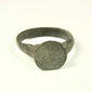 Roman to Early Byzantine bronze ring, US size 8, with broad circular bezel and intact tapered hoop, circa 1st–8th century CE