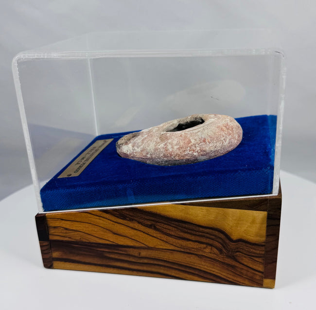Ancient oil lamp exhibited within a custom acrylic and velvet presentation display