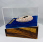 Ancient oil lamp exhibited within a custom acrylic and velvet presentation display