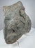 Ancient Roman volcanic stone carving with eroded figural composition, porous surface and mineral deposits