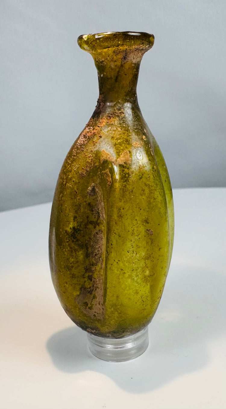 Ancient Roman olive green glass vessel used for perfumes, oils, cosmetics, or medicinal preparations