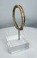Historic Roman glass jewelry artifact with raised decorative elements and complete form.