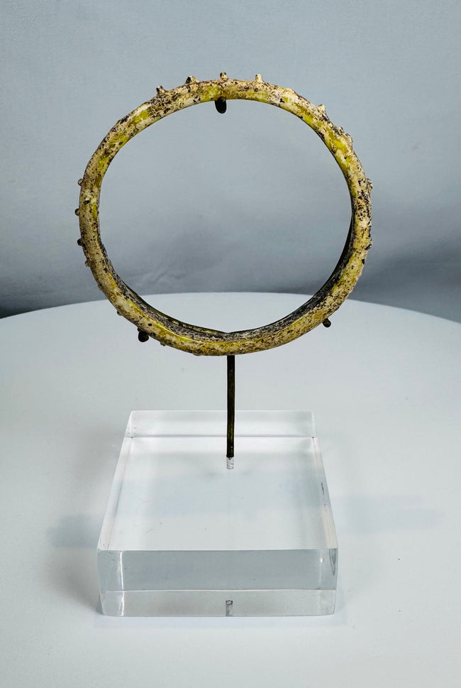 Ancient Roman blue-green glass bracelet with applied decorative protrusions and iridescent weathering.
