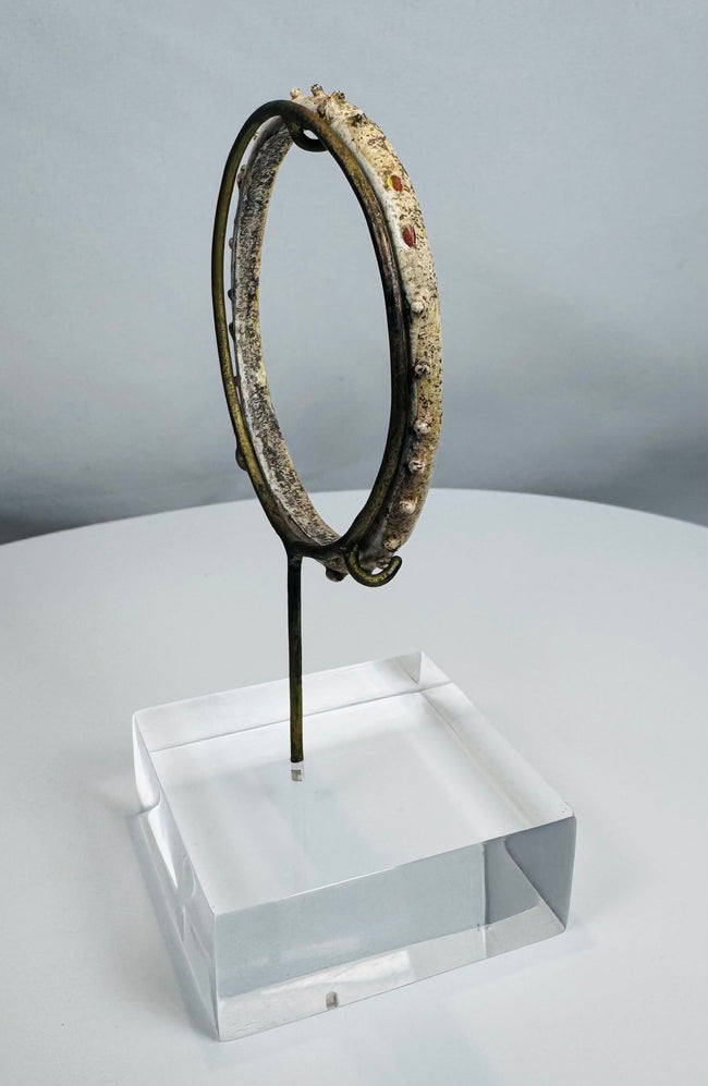 Ancient Roman personal adornment crafted from glass with applied decorative nodules.
