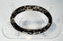 Ancient Roman glass bracelet showing dark cobalt or near-black glass beneath surface weathering