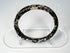 Close view of Roman glass bangle with pitting, exfoliation, and iridescent archaeological surface