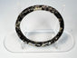 Close view of Roman glass bangle with pitting, exfoliation, and iridescent archaeological surface
