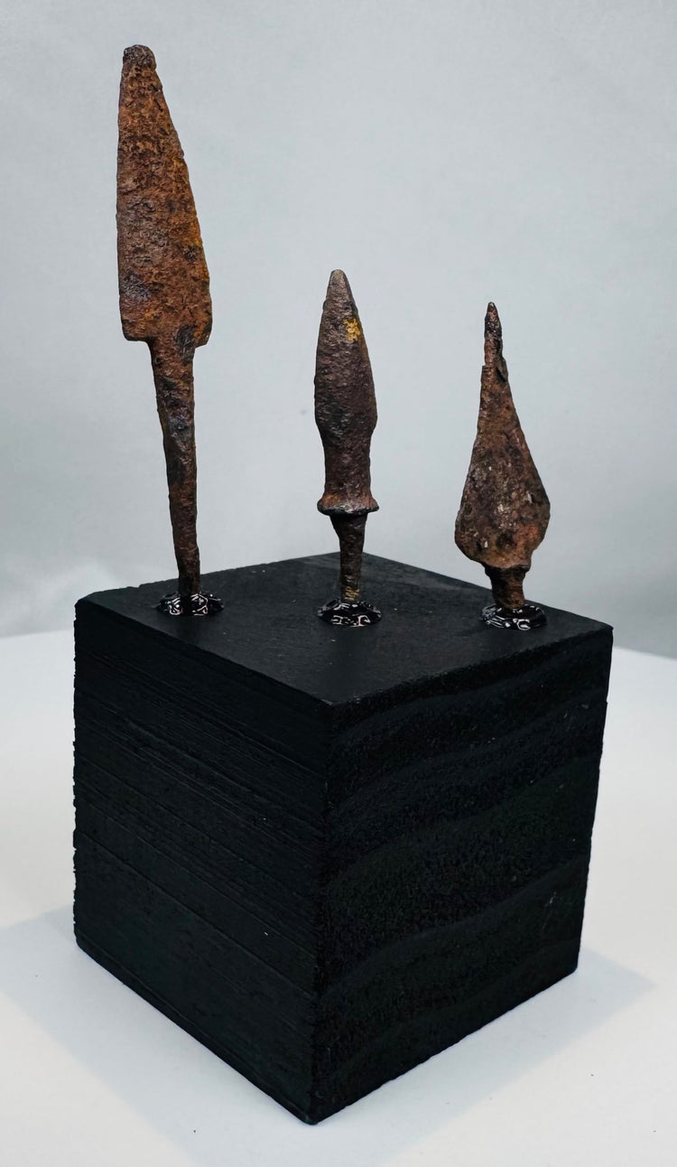 Side view of three archaeological iron arrow, javelin, or light spear points