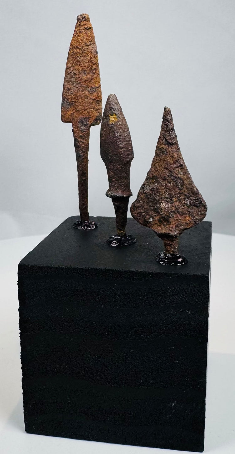 Close-up of hand-forged Roman iron points with mineral encrustation and oxidation