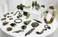 Ancient Roman bronze artifact collection featuring belt fittings, decorative appliqués, harness mounts, and a small spearhead from the Roman Imperial period