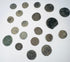 Ancient bronze coin collection showing heavily patinated surfaces, irregular edges, and surviving traces of imperial and reverse designs.