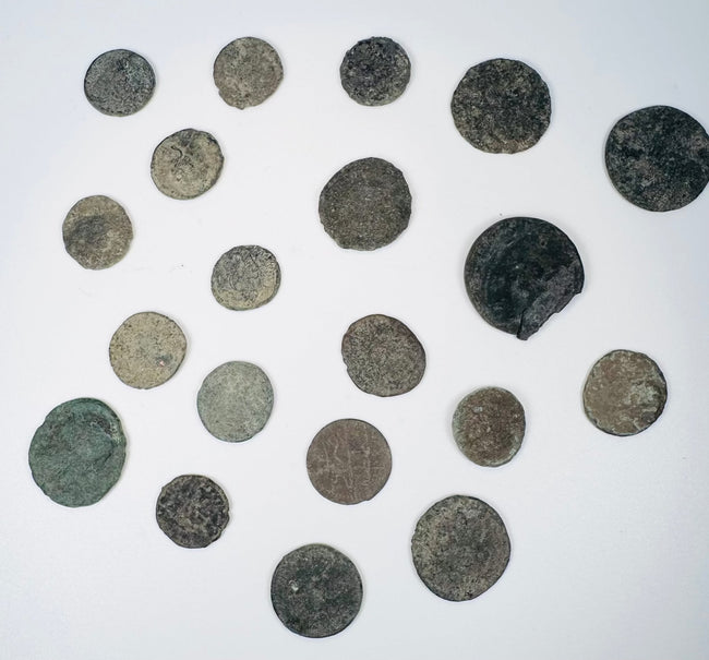 Mixed group of Roman Imperial and possible early Byzantine copper-alloy coins with worn portraits, inscriptions, and mineral encrustation.