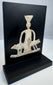 Ancient lead-alloy devotional plaque with ependytes garment and geometric pedestal motif