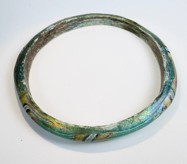 Ancient Roman bracelet displaying fused polychrome glass decoration and remarkable preservation.