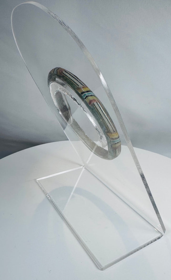 Historic Roman polychrome glass bracelet featuring a complete bangle form and vivid decorative bands.