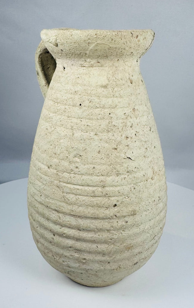 Ancient Roman terracotta pitcher from Africa Proconsularis with ribbed body and flared rim.