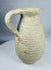 Roman North African pottery pitcher displaying mineral deposits, weathering, and ancient earthenware surfaces.