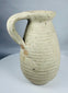 Roman North African pottery pitcher displaying mineral deposits, weathering, and ancient earthenware surfaces.