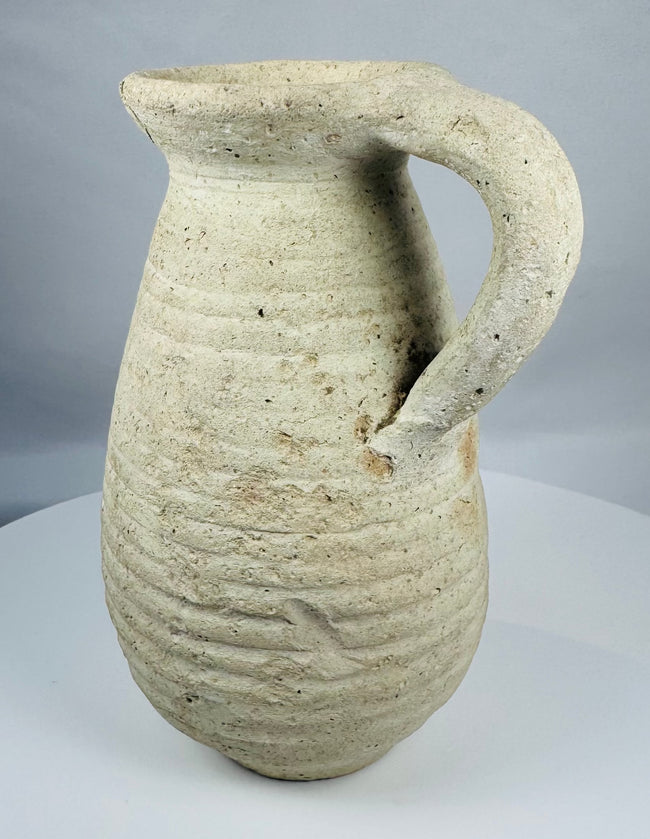 Ancient Tunisian terracotta vessel dating to the Roman Imperial period with a sturdy loop handle.
