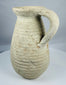 Ancient Tunisian terracotta vessel dating to the Roman Imperial period with a sturdy loop handle.