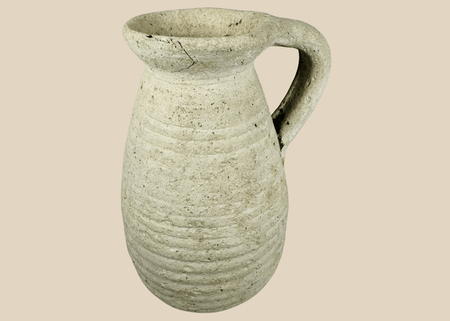 Ancient Roman North African terracotta pitcher from modern Tunisia with ribbed body and loop handle.