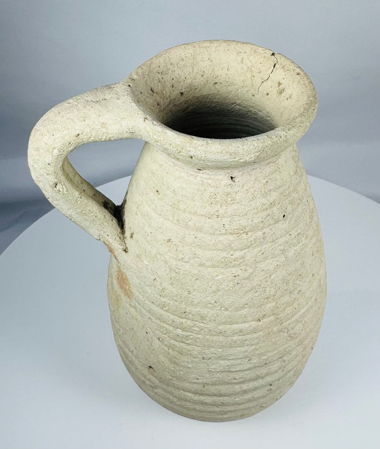 Roman Imperial terracotta pitcher featuring a rounded body, recessed neck, and broad flaring rim.