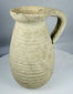 Authentic Roman North African earthenware pitcher with horizontal ribbed decoration and archaeological patina.
