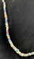 Roman Imperial glass beads displaying striped decoration and surface iridescence