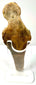 Rear view of flat-backed ancient terracotta figurine showing weathered clay surface and chips
