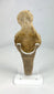 Rear view of ancient terracotta fertility figure with surface patina and age-related wear.
