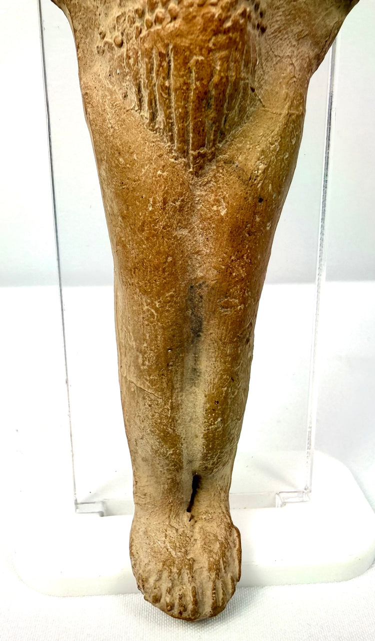 Ancient Roman terracotta fertility figurine detail showing stylized toes and incised shin lines