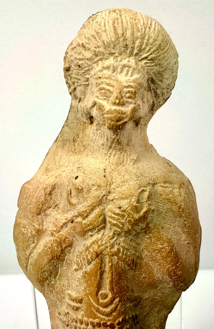 Close-up of ancient Roman terracotta bust featuring high bun hairstyle and decorated abdomen