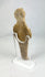 Side view of Roman fertility statuette highlighting form, texture, and ritual posture.