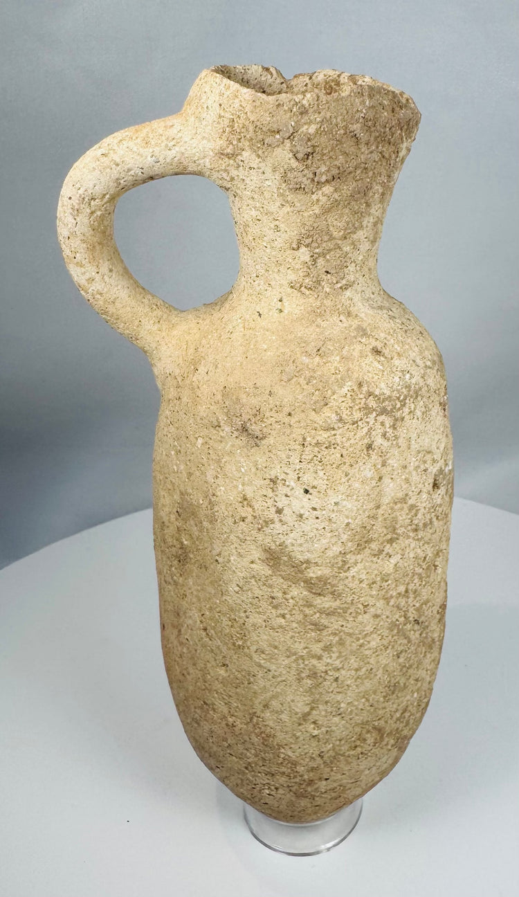Authentic Roman terracotta storage vessel with a rounded body, loop handle, and weathered archaeological surface.