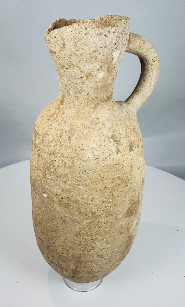 Roman Provincial earthenware vessel with a broad cylindrical neck, applied handle, and archaeological patina.