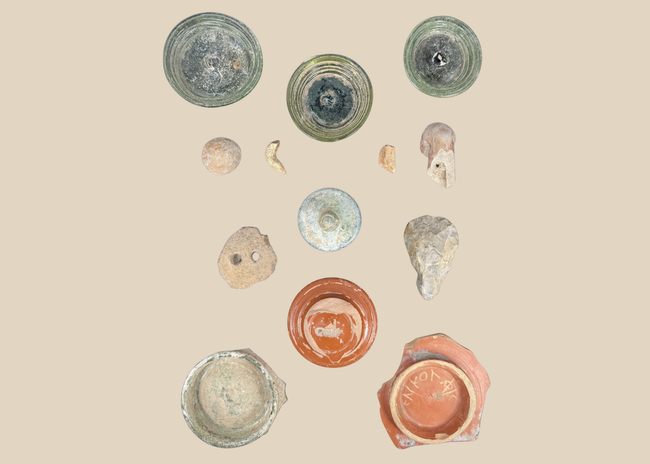Comparative archaeological shadow-box showing ancient glass, ceramics, and stone artifacts