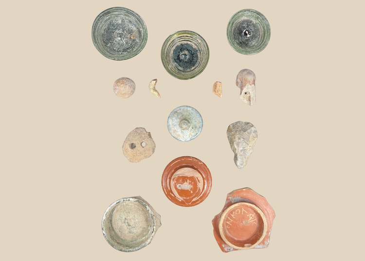 Comparative archaeological shadow-box showing ancient glass, ceramics, and stone artifacts
