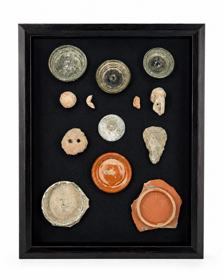Framed archaeological study collection with thirteen ancient glass, pottery, terracotta, and stone fragments