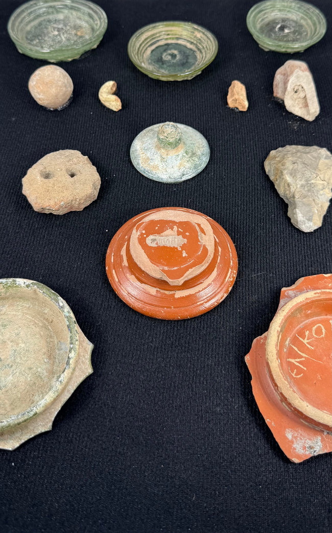 Ancient Eastern Mediterranean artifact display with glass, pottery, terracotta, and worked stone