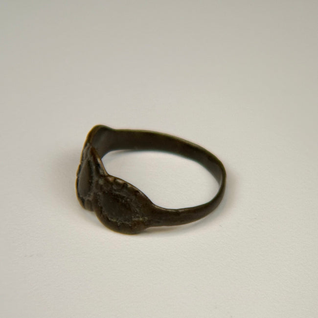 Ancient silver ring with interconnected oval motifs and naturally weathered surface patina