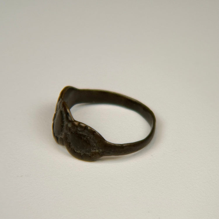 Ancient silver ring with interconnected oval motifs and naturally weathered surface patina