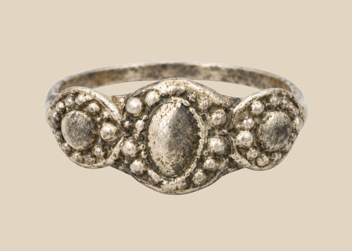 Ancient Late Roman–Byzantine silver ring featuring a clustered bezel of three oval motifs with natural aged patina, circa 300–600 CE.