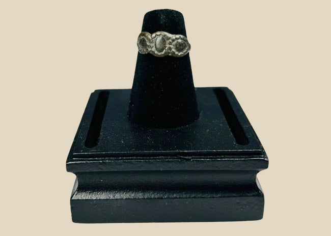 Ancient Late Roman–Byzantine silver ring featuring a clustered bezel of three oval motifs with natural aged patina, circa 300–600 CE.